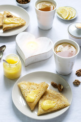 Breakfast for two with pancakes, lemon cream and tea. Breakfast on Valentine's Day.