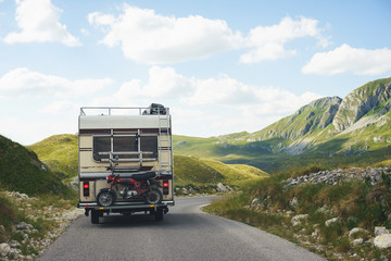 Euro-trip. Old stylish classic motorhome on the road in the mountains. 