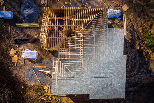 Peeling back the shingles to look at the newly framed walls and rafters on a future home.