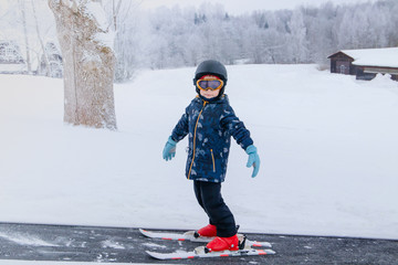 Fototapeta na wymiar Kids learning alpine skiing on learning hill.