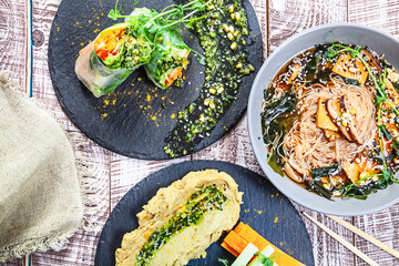 Top view on vegetarian table served. Various vegan food on a white background. Food party table concept. Healthy homemade vegan food or snack. Copy free space for logo, text or brand.