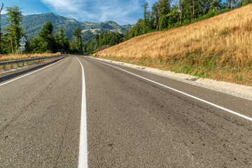 Road to the mountains. Sunny morning.