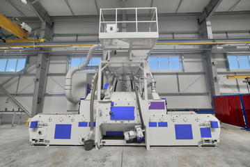 Interior of a modern factory. A bright large workshop, inside there is a shot blasting unit