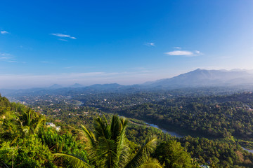 Fototapeta na wymiar Foggy aerial panorama of Kandy, Sri Lanka at the sunrise, view from the mountain