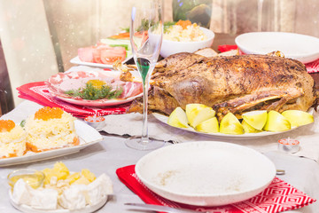Christmas roast duck with apples served on a festive table