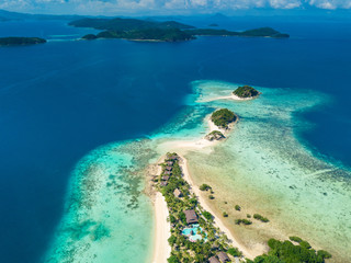 Aerial view of tropical island Bulalacao. Beautiful tropical island with white sandy beach, palm trees and green hills. Travel tropical concept. Palawan, Philippines