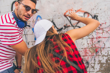 Urban couple writing on wall