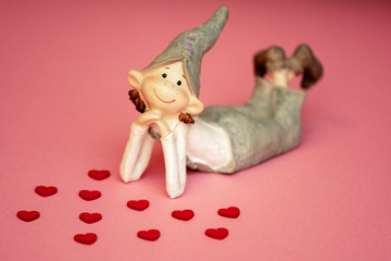 loving boy elf ceramic with hearts on coral background