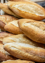 Display of handmade bread loaves on the counter top of a modern bakery to entice customers to buy