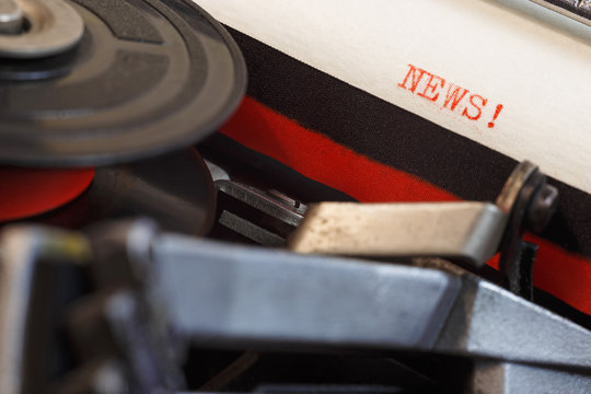 Vintage typewriter with typed text "News". Close up
