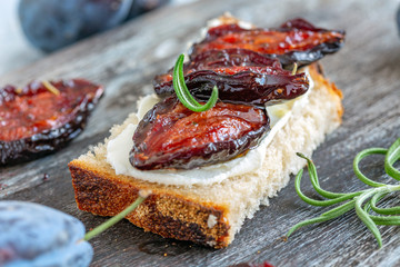 Appetizer of homemade bread and spicy dried plums.