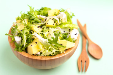 Delicious salad with frisee, mango, feta and crunchy croutons