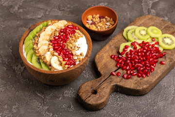 Vanilla acai bowl with kiwi, banana, pomegranate and granola