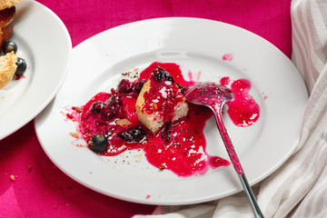 Delicious toasts bread with homemade currant jam on bright crimson tablecloth