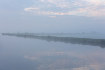 A foggy morning water landscape on the Kagerplassen in the Netherlands.