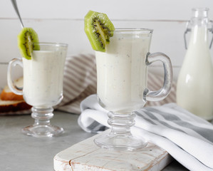 Fresh blended  kiwi protein smoothie with yogurt or milk in glass jar, healthy eating