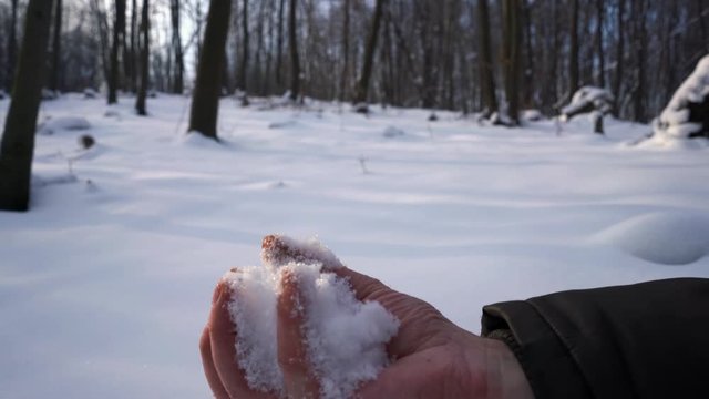 Man make snowball with hands - (4K)