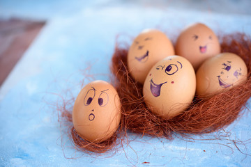 Funny little donkey on Easter eggs on a blue background. Different faces on the eggs. Emotions....