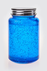  Transparent glass bottle with a liquid collagen gel of serum isolated on white background. Blue cosmetic gel with bubbles. 