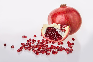 Close-up of pomegranate seeds texture on a white background, top view.  Ripe red garnet fruit Close-up of pomegranate seeds texture on a white background, top view.  Ripe red garnet fruit 