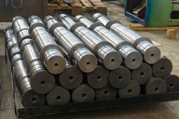 Fototapeta na wymiar Metal shafts stacked in a row in stock