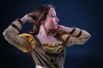 Expressive emotional princess girl in retro carnival dress. Dark background