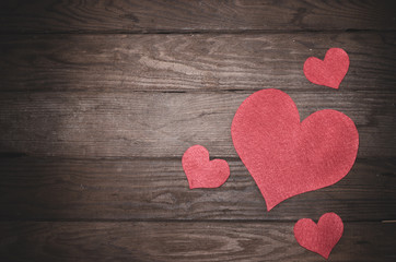 Heart made of felt on a wooden table. Frame to the day of Saint Valentine.