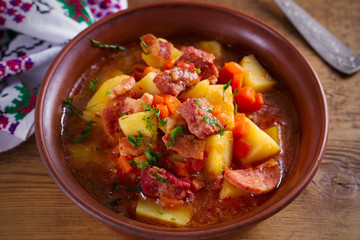 Delisious homemade stew. Goulash soup in a bowl on wooden table. horizontal.