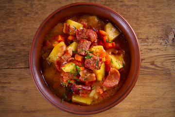 Delisious homemade stew. Goulash soup in a bowl on wooden table. horizontal, overhead