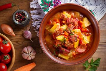 Delisious homemade stew. Goulash soup in a bowl on wooden table. horizontal, overhead