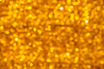 Abstract blurred shiny yellow background with bright lights.