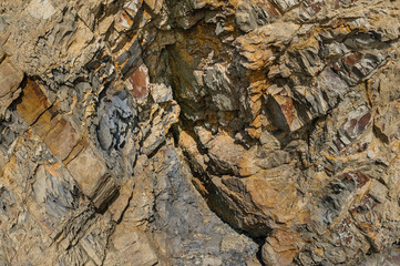 Texture of a dark yellow granite stone or background for design..Surface of the rock with an abstract pattern.