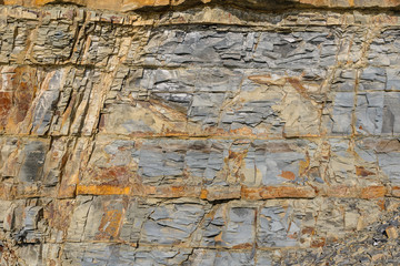 Texture of a dark yellow granite stone or background for design..Surface of the rock with an abstract pattern.