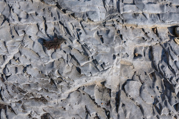 Texture of dark gray slate or background for design..The surface of the rock is a surface with a wave pattern.