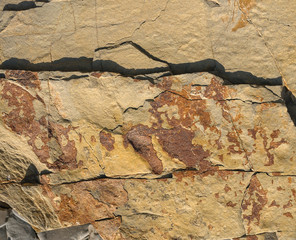 Texture of a dark gray stone or background for design..The surface of the rock is a surface with a wave pattern.