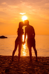 young couple is kissing at the sea