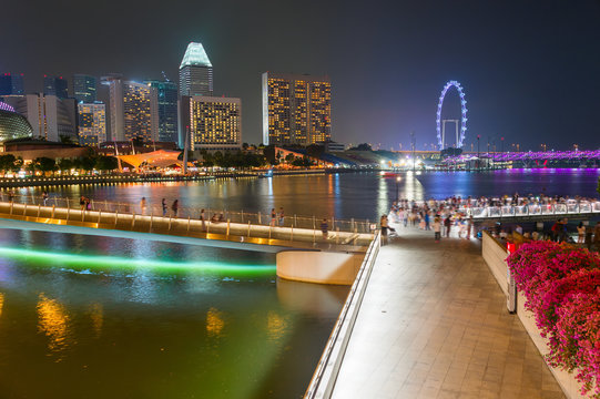 Tourists walking Flyer Singapore embankment
