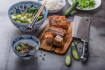 Asian roasted pork belly with crispy skin on concrete background