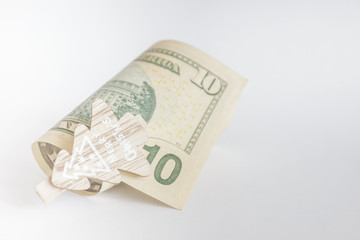 American dollars with decorative clothes pins, light background