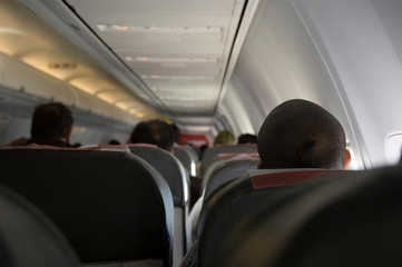 People sit in the aircraft cabin and waiting for departure