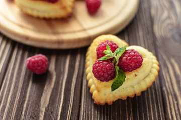 Delicious heart-shaped muffins with raspberries and mint. Cupcakes for Valentine's Day
