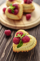Delicious heart-shaped muffins with raspberries and mint. Cupcakes for Valentine's Day