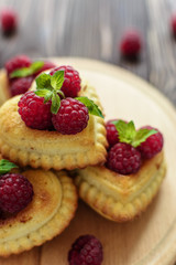 Delicious heart-shaped muffins with raspberries and mint. Cupcakes for Valentine's Day