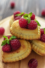 Delicious heart-shaped muffins with raspberries and mint. Cupcakes for Valentine's Day