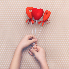 Valentine's Day background with red hearts on straws. Valentine Day. Heart pendant. Space for text....