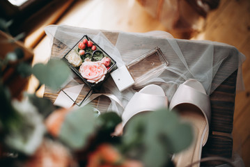 Elements of wedding decor. Wedding rings, perfume, wedding bouquet with different fresh flowers. Top view