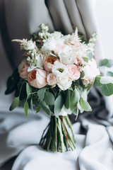 Bridal bouquet. Very beautiful wedding bouquet of fresh flowers of white and pastel pink roses