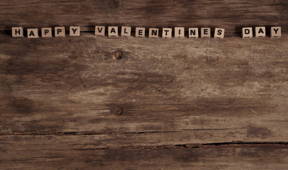 wooden blocks with text Happy Valentines day on vintage rustic wood background