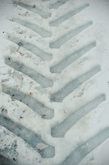 Tractor footprints in the snow on a winter day