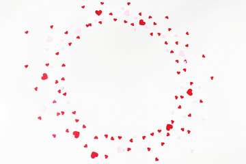 Valentines day or wedding festive composition. Circle made of red and pink paper heart shaped...